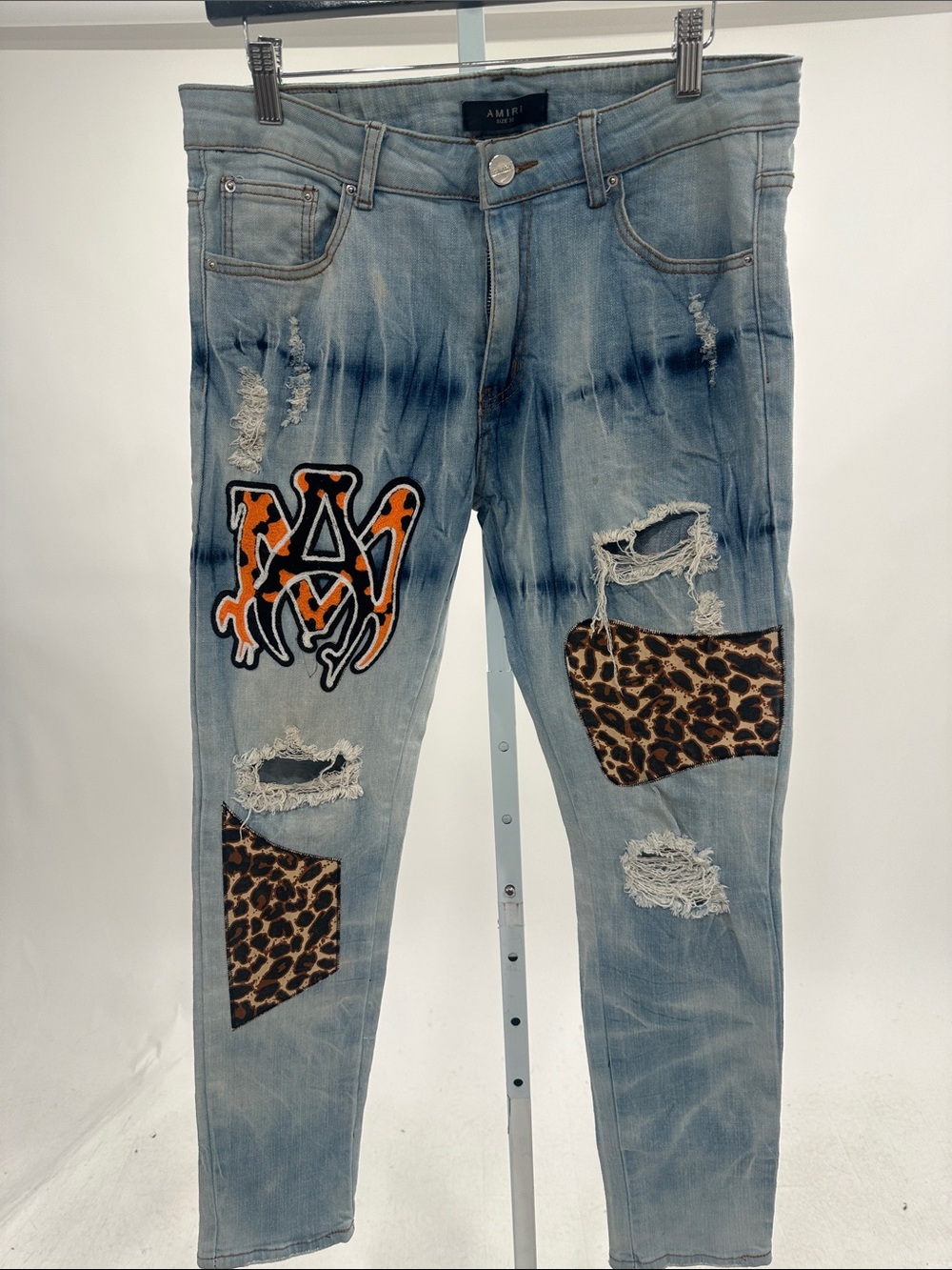 AMIRI Light Blue Skinny Jeans with Leopard Patch and Orange Logo
